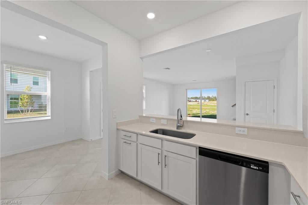 14792 Bluewater Road Babcock Ranch, FL 33982 - Photo 18 of 42 a kitchen with sink cabinets and window