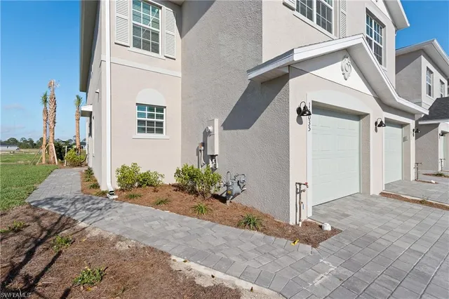 a view of a house with a flower garden