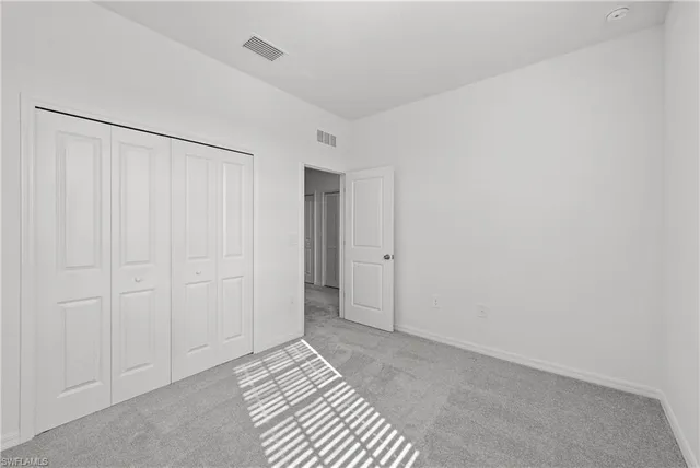 a view of a livingroom with an empty space and a bathroom
