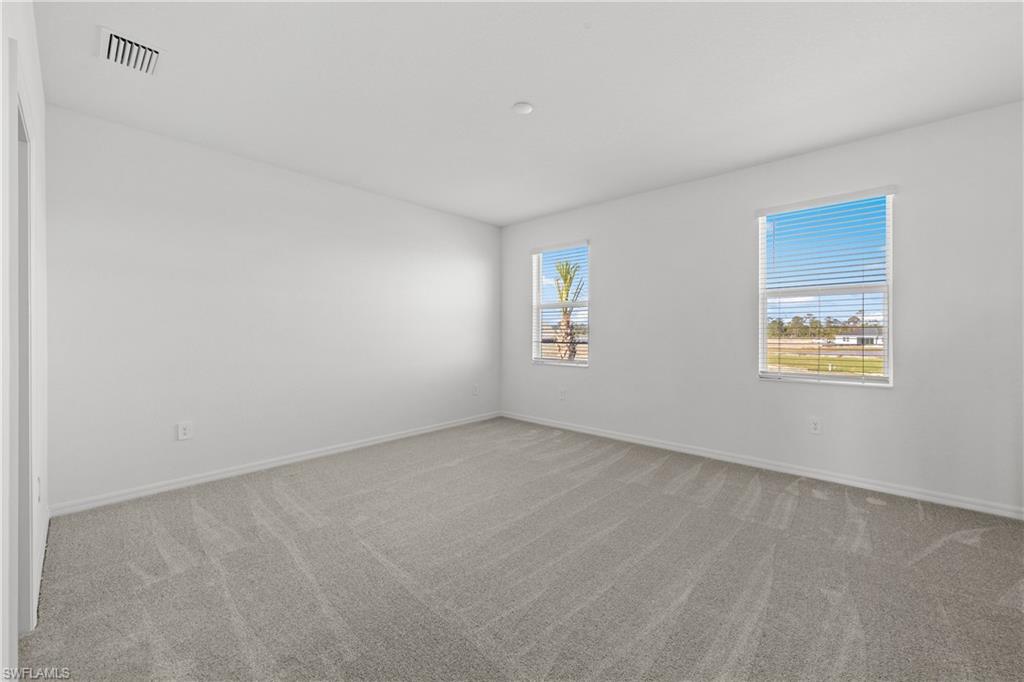 14792 Bluewater Road Babcock Ranch, FL 33982 - Photo 38 of 42 an empty room with windows