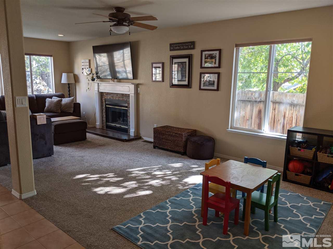 5485 Tappan Drive Reno, NV 89523 - Photo 8 of 25 a living room with furniture a window and a fireplace