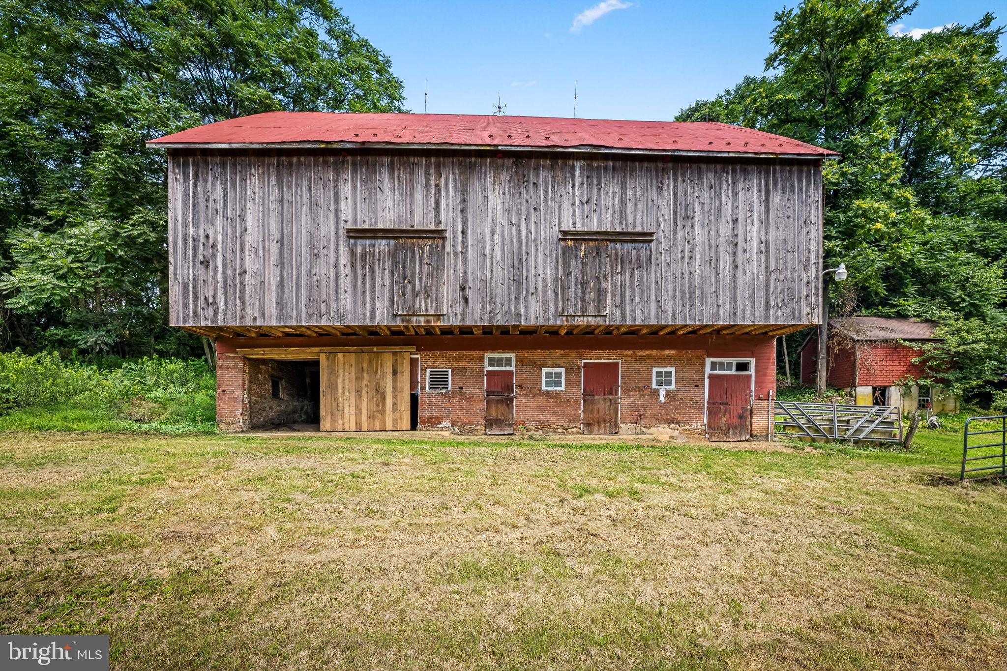16756 Mount Airy Road Shrewsbury, PA 17361 - Photo 2 of 93 Charming rustic barn with vibrant greenery.