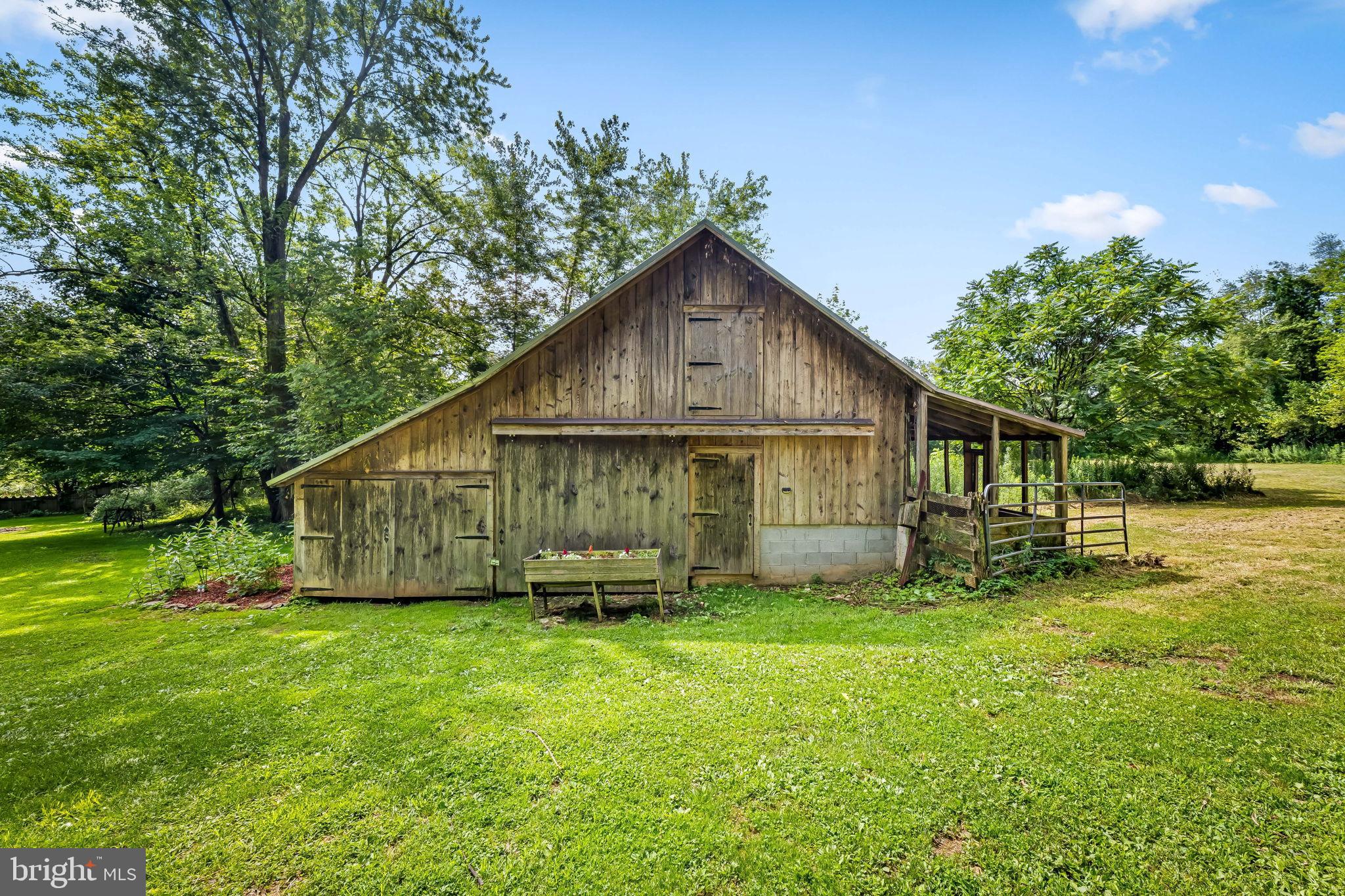 16756 Mount Airy Road Shrewsbury, PA 17361 - Photo 27 of 93 Charming rustic barn amidst lush greenery.