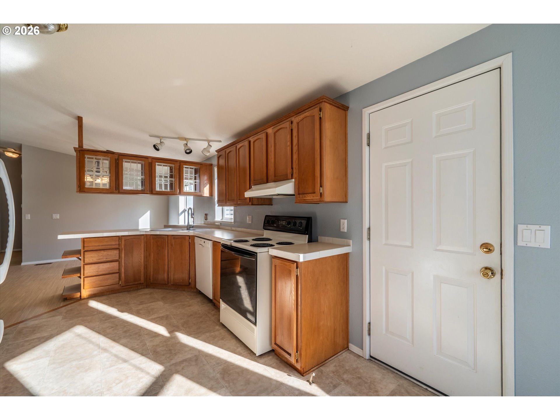 887 Jackson Avenue Southwest Bandon, OR 97411 - Photo 11 of 29 a kitchen with stainless steel appliances granite countertop a stove a sink and a refrigerator