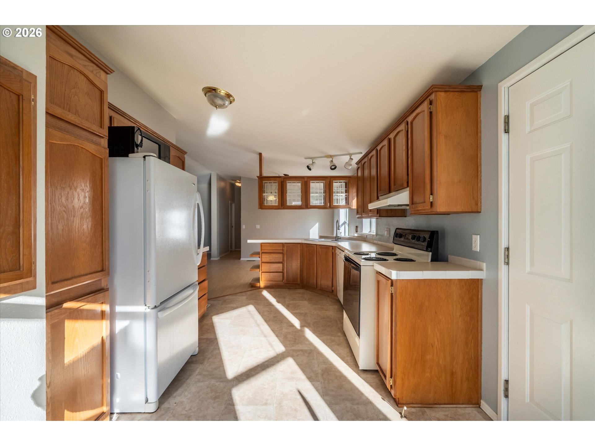 887 Jackson Avenue Southwest Bandon, OR 97411 - Photo 12 of 29 a kitchen with stainless steel appliances granite countertop a refrigerator a stove and a refrigerator with wooden floor