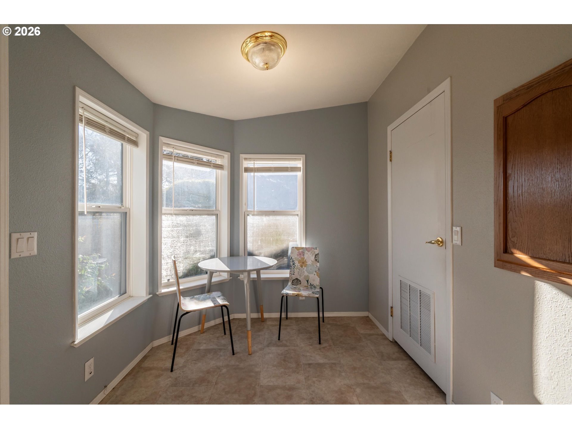 887 Jackson Avenue Southwest Bandon, OR 97411 - Photo 13 of 29 a dining room with furniture and a floor to ceiling window