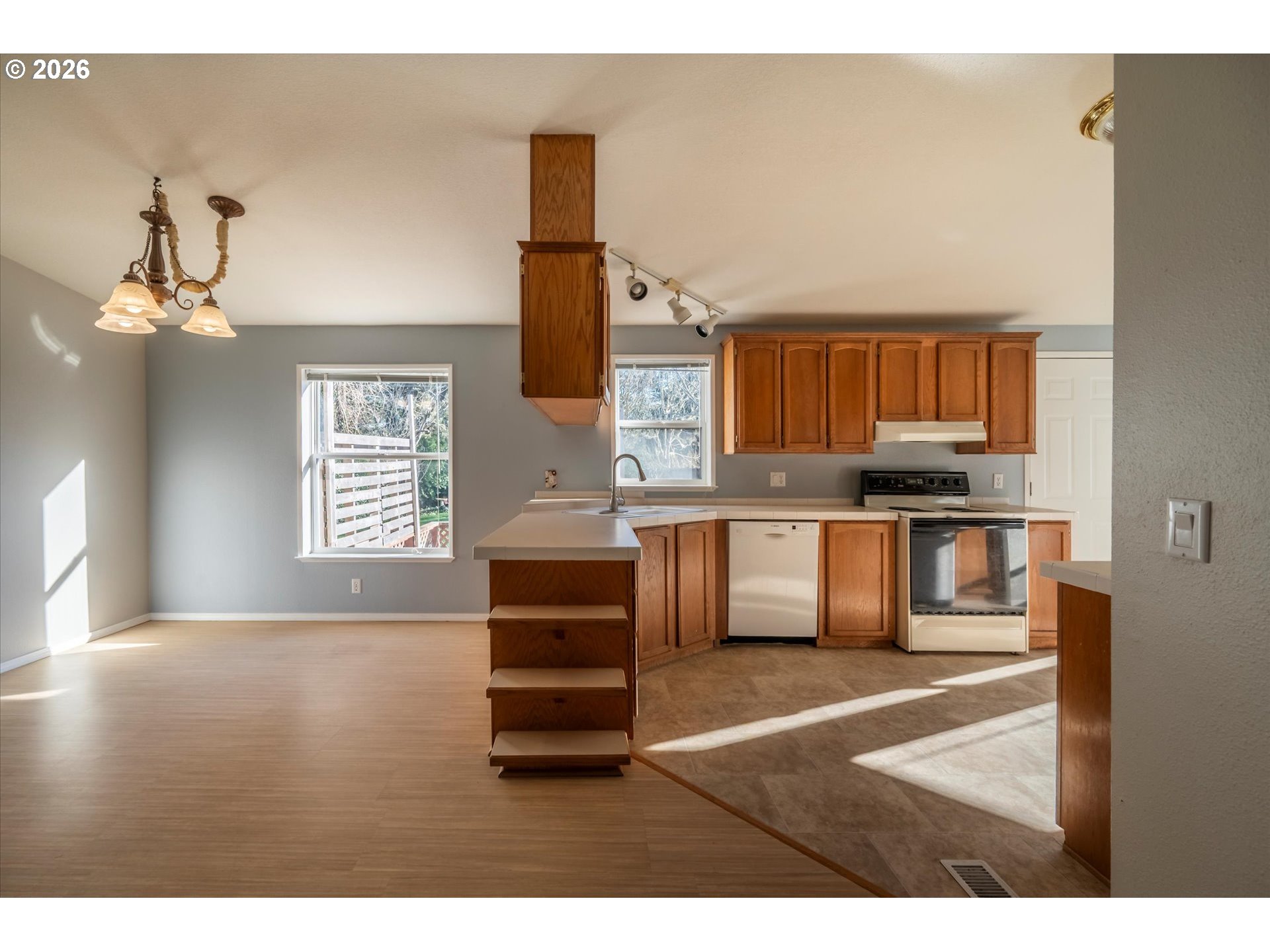 887 Jackson Avenue Southwest Bandon, OR 97411 - Photo 17 of 29 a kitchen with granite countertop a sink cabinets and stainless steel appliances