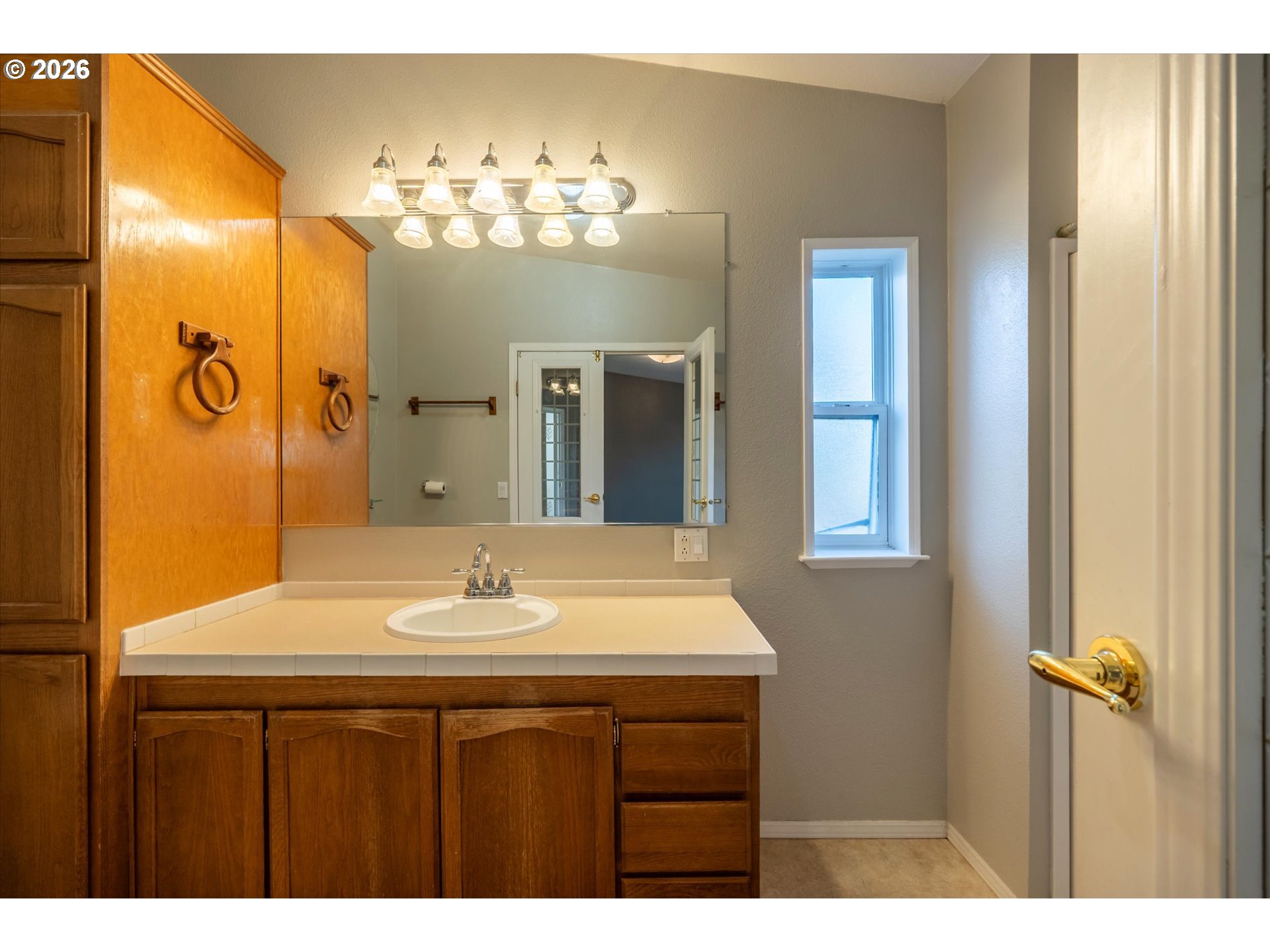 887 Jackson Avenue Southwest Bandon, OR 97411 - Photo 27 of 29 a bathroom with a sink vanity and a mirror