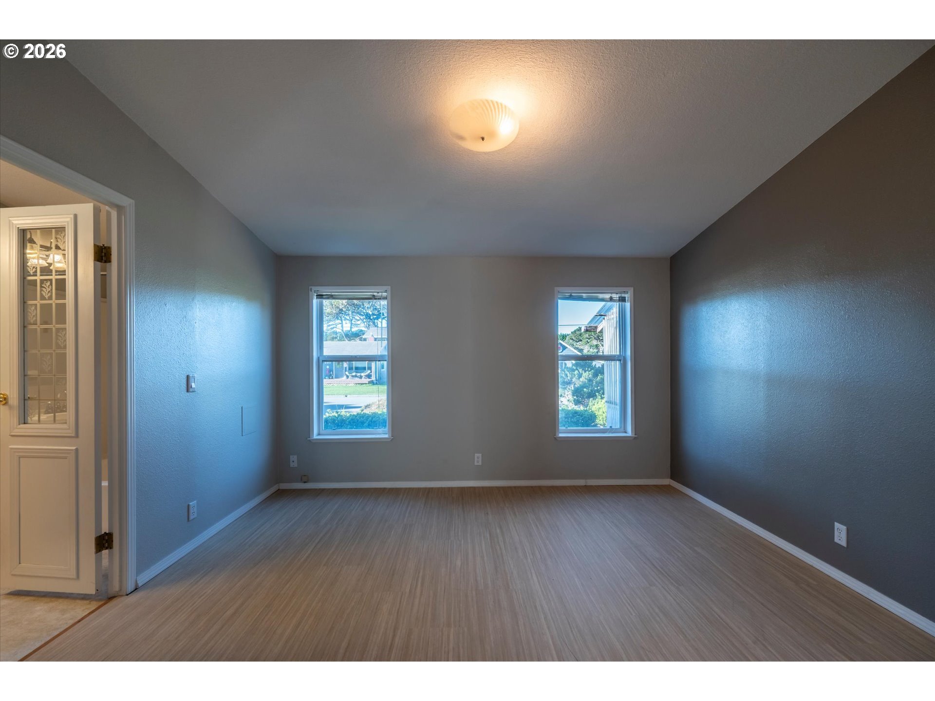 887 Jackson Avenue Southwest Bandon, OR 97411 - Photo 29 of 29 a view of an empty room with window and wooden floor