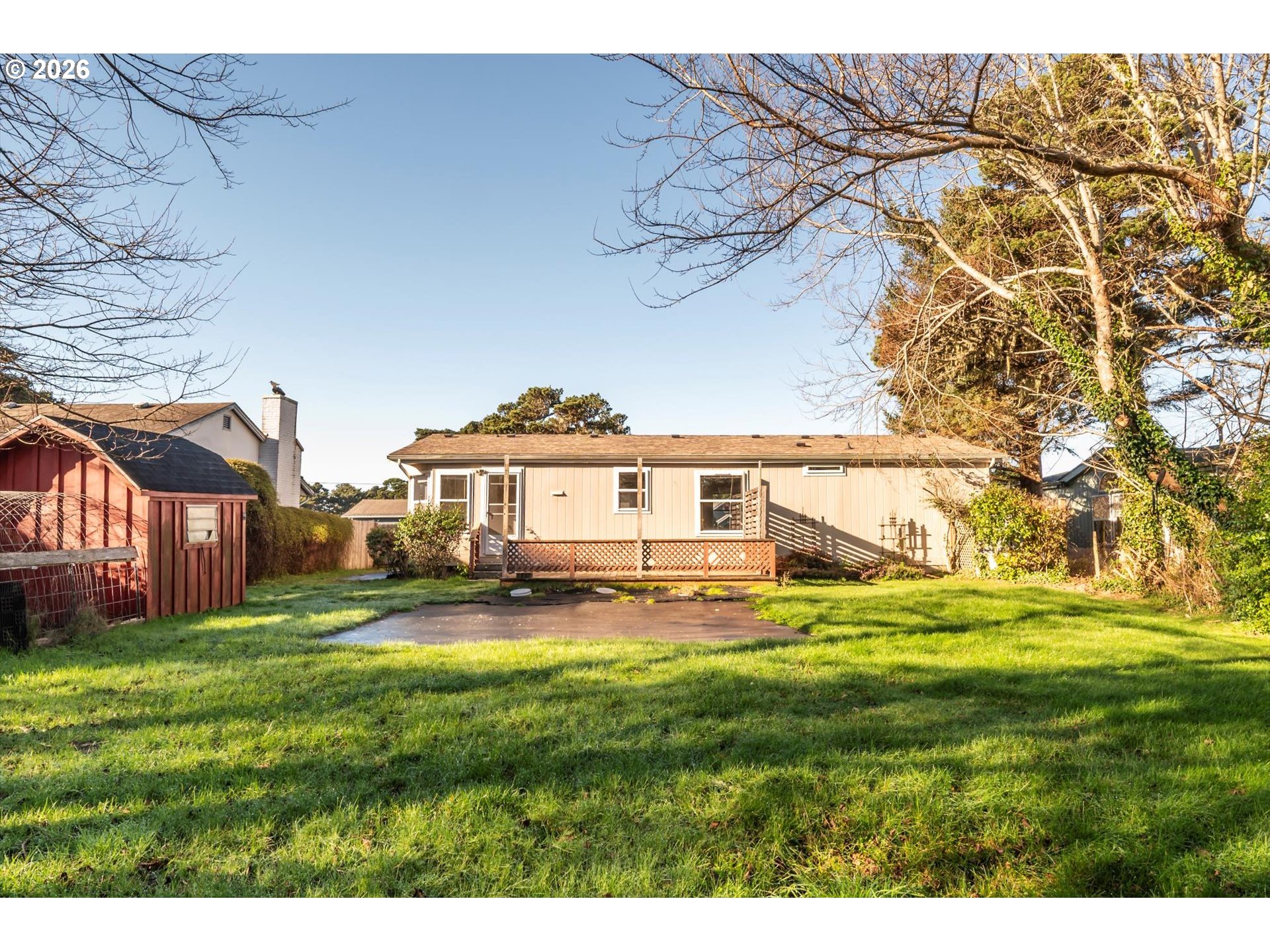 887 Jackson Avenue Southwest Bandon, OR 97411 - Photo 4 of 29 a view of a yard in front of a house with a big yard