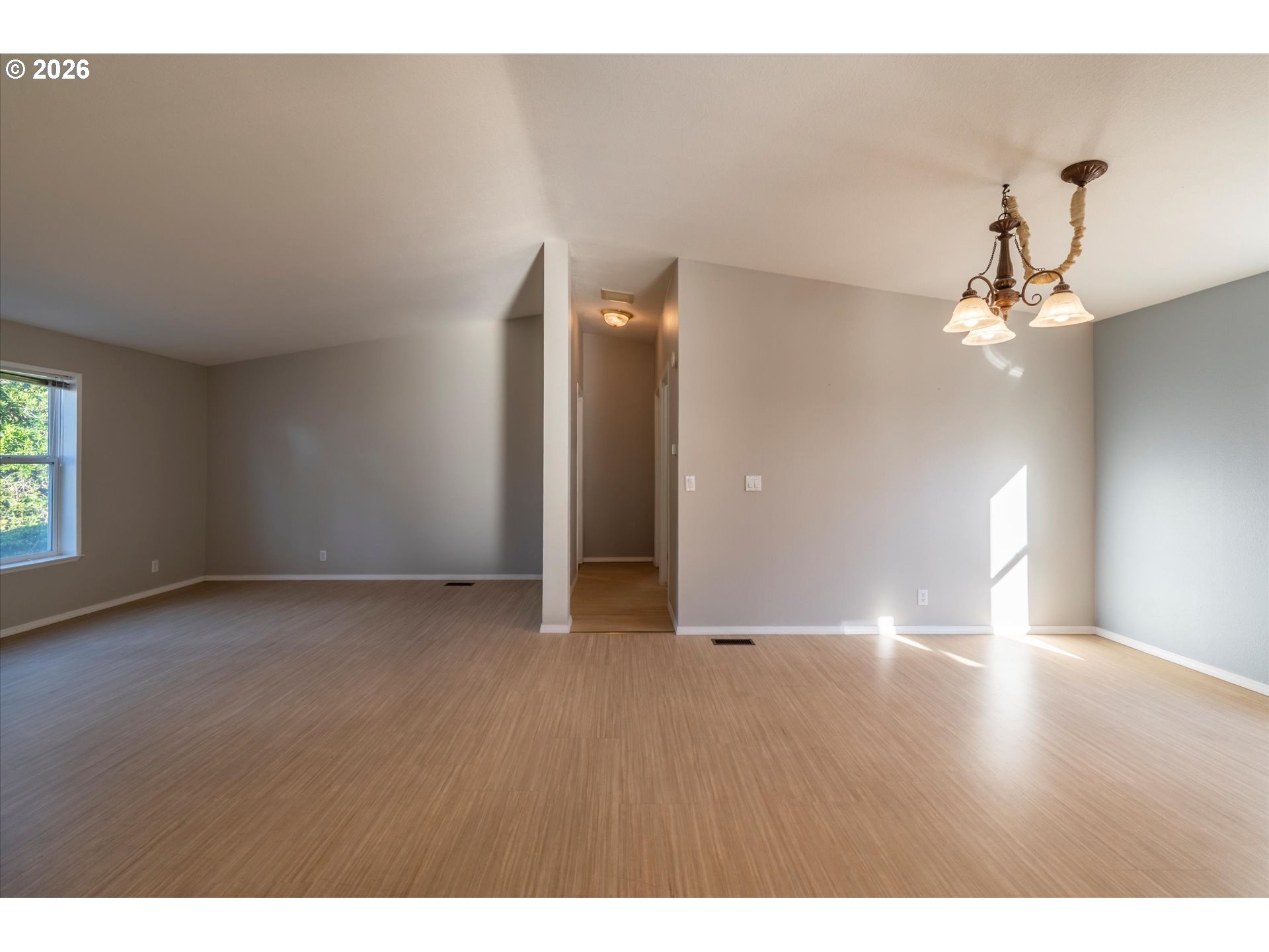 887 Jackson Avenue Southwest Bandon, OR 97411 - Photo 7 of 29 a view of an empty room with wooden floor