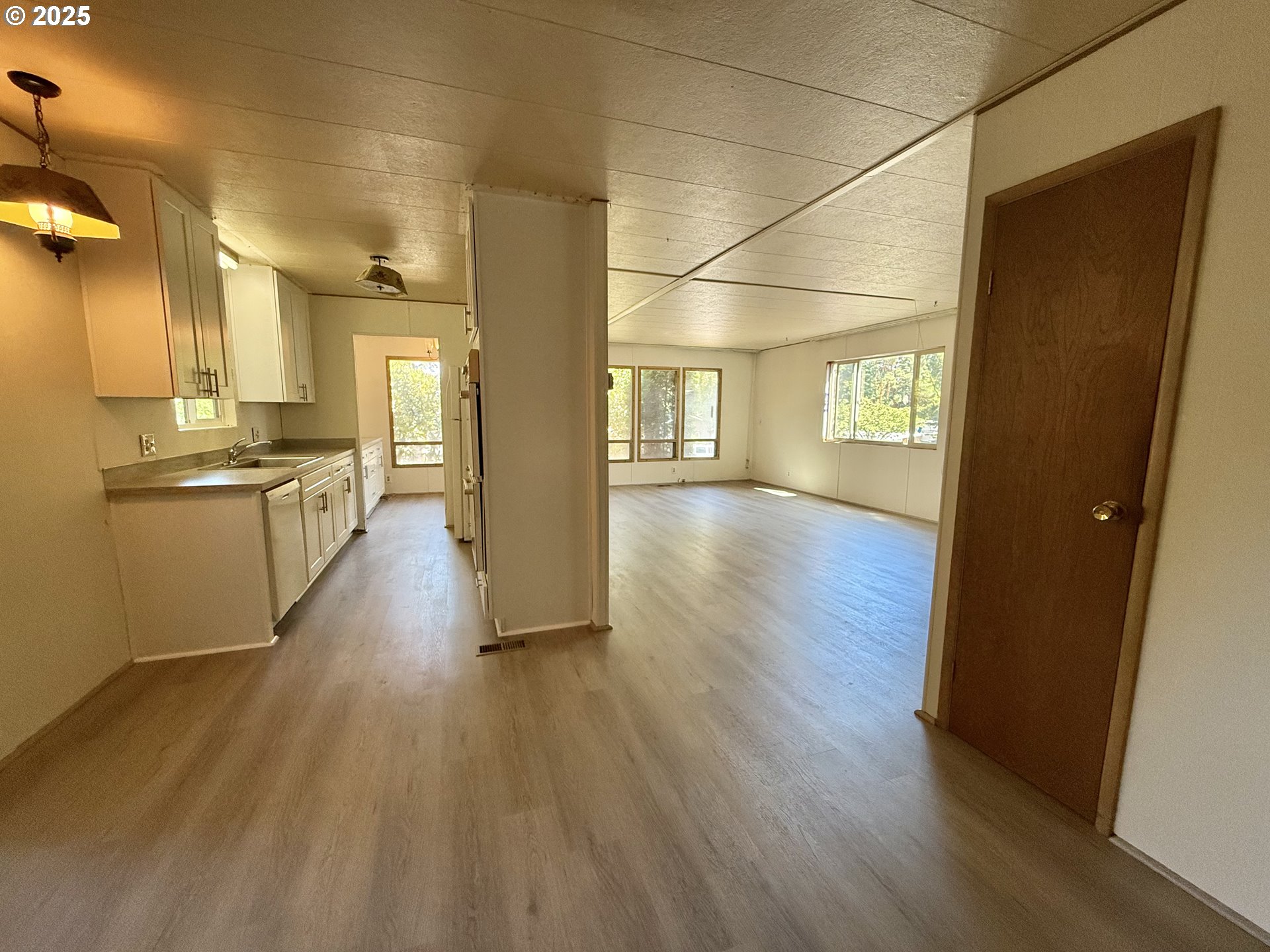 6900 Southwest 195th Avenue Beaverton, OR 97007 - Photo 11 of 21 a view of a hallway with wooden floor and a bathroom