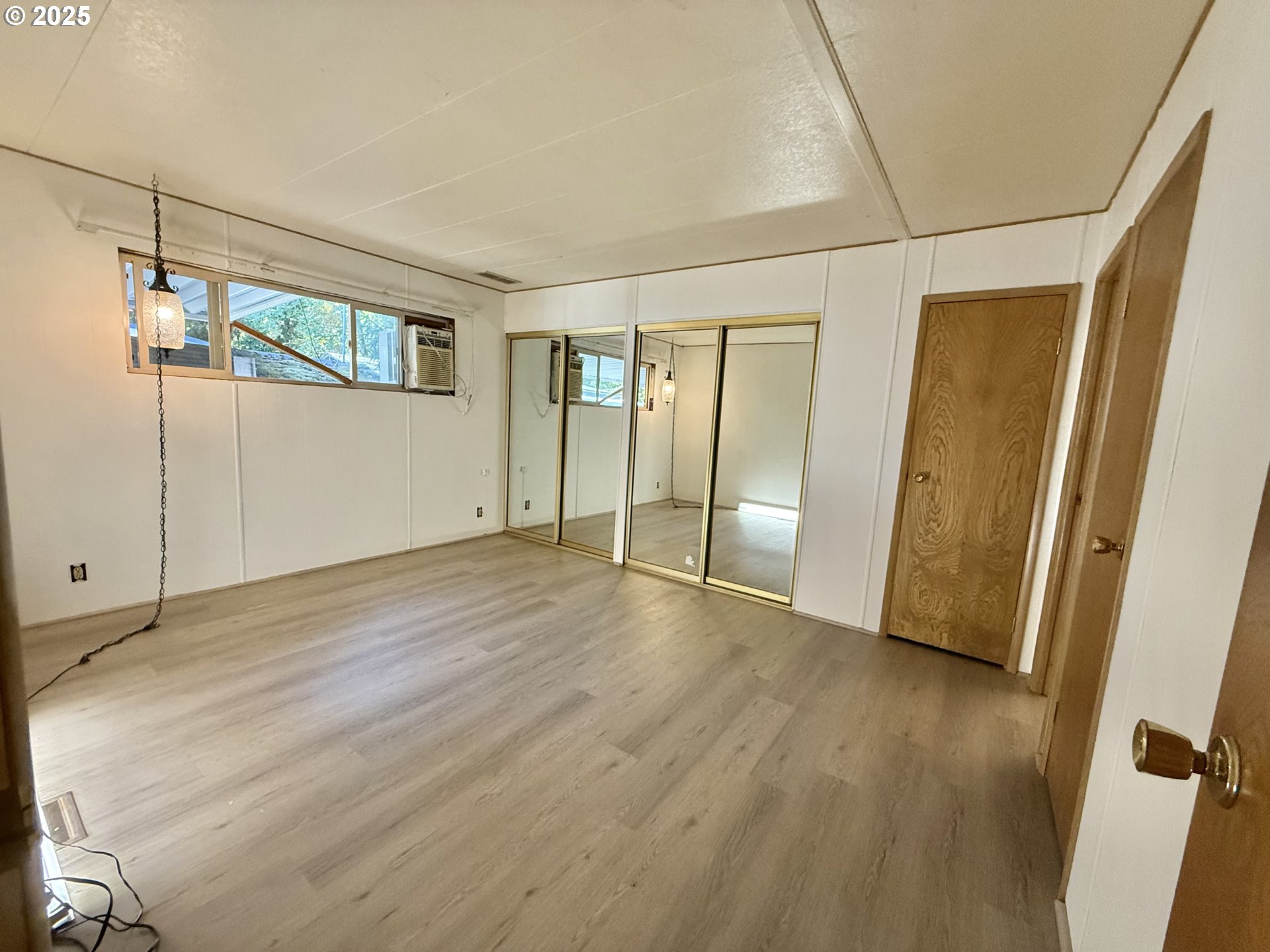 6900 Southwest 195th Avenue Beaverton, OR 97007 - Photo 18 of 21 an empty room with wooden floor and windows