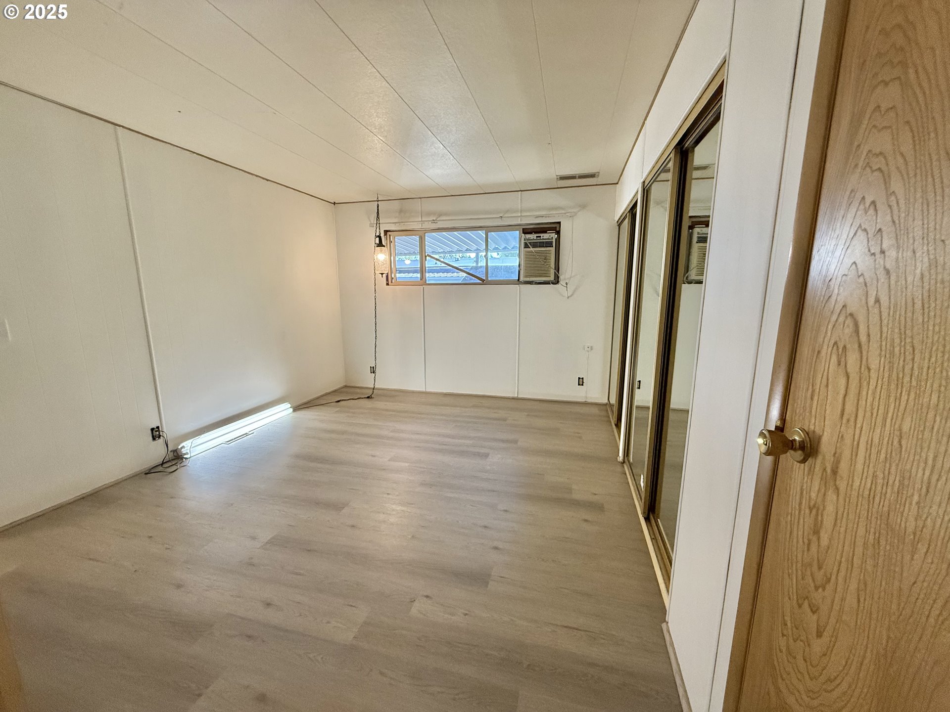 6900 Southwest 195th Avenue Beaverton, OR 97007 - Photo 19 of 21 a view of a hallway with wooden floor and cabinet