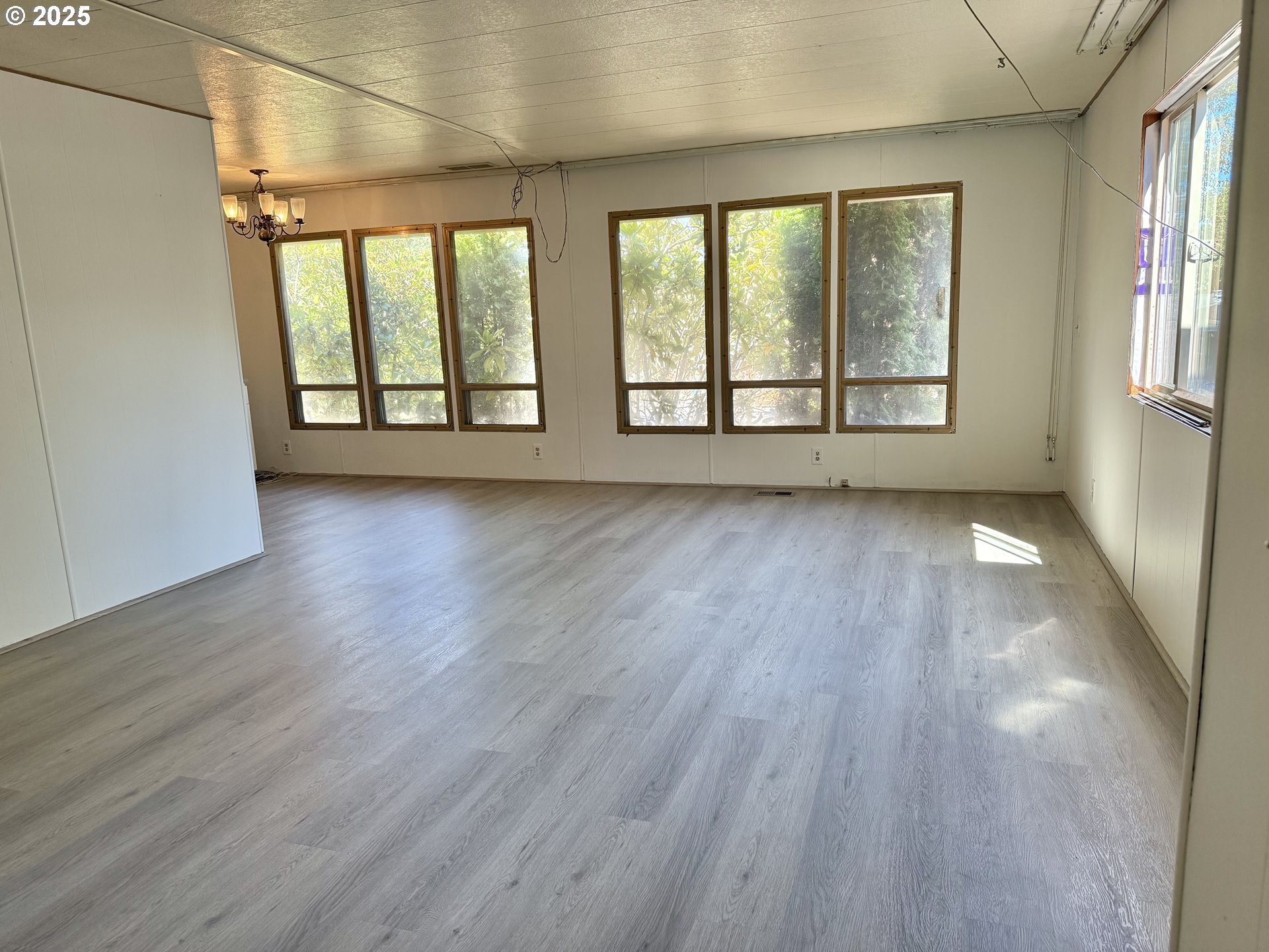 6900 Southwest 195th Avenue Beaverton, OR 97007 - Photo 5 of 21 wooden floor in an empty room with a window