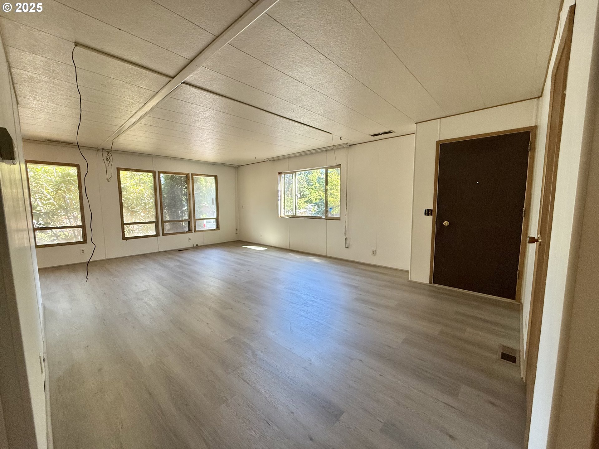 6900 Southwest 195th Avenue Beaverton, OR 97007 - Photo 6 of 21 an empty room with wooden floor and windows