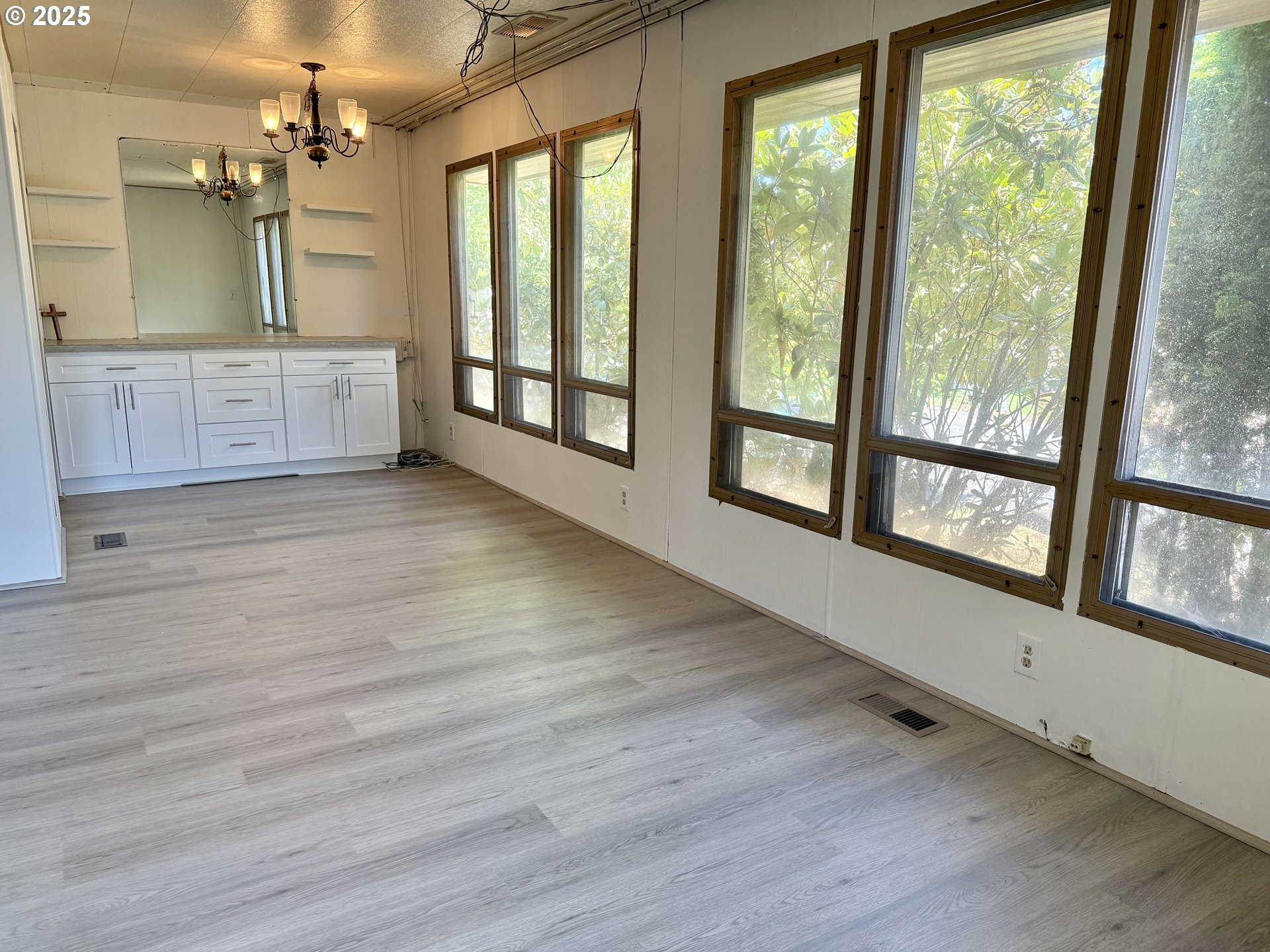 6900 Southwest 195th Avenue Beaverton, OR 97007 - Photo 7 of 21 an empty room with wooden floor and windows