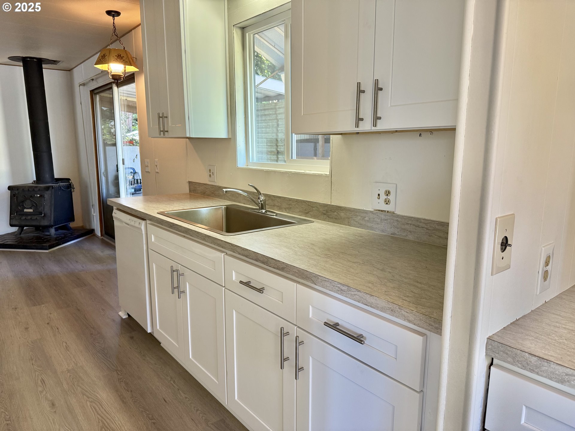 6900 Southwest 195th Avenue Beaverton, OR 97007 - Photo 9 of 21 a kitchen with a sink and cabinets