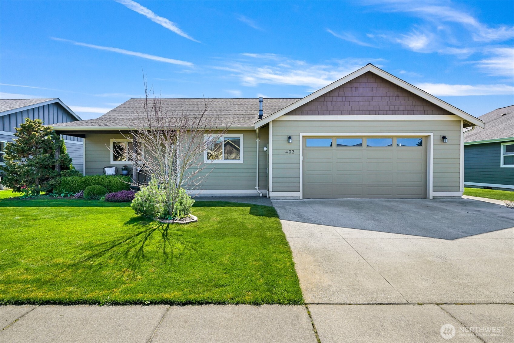 a front view of a house with a yard and garage