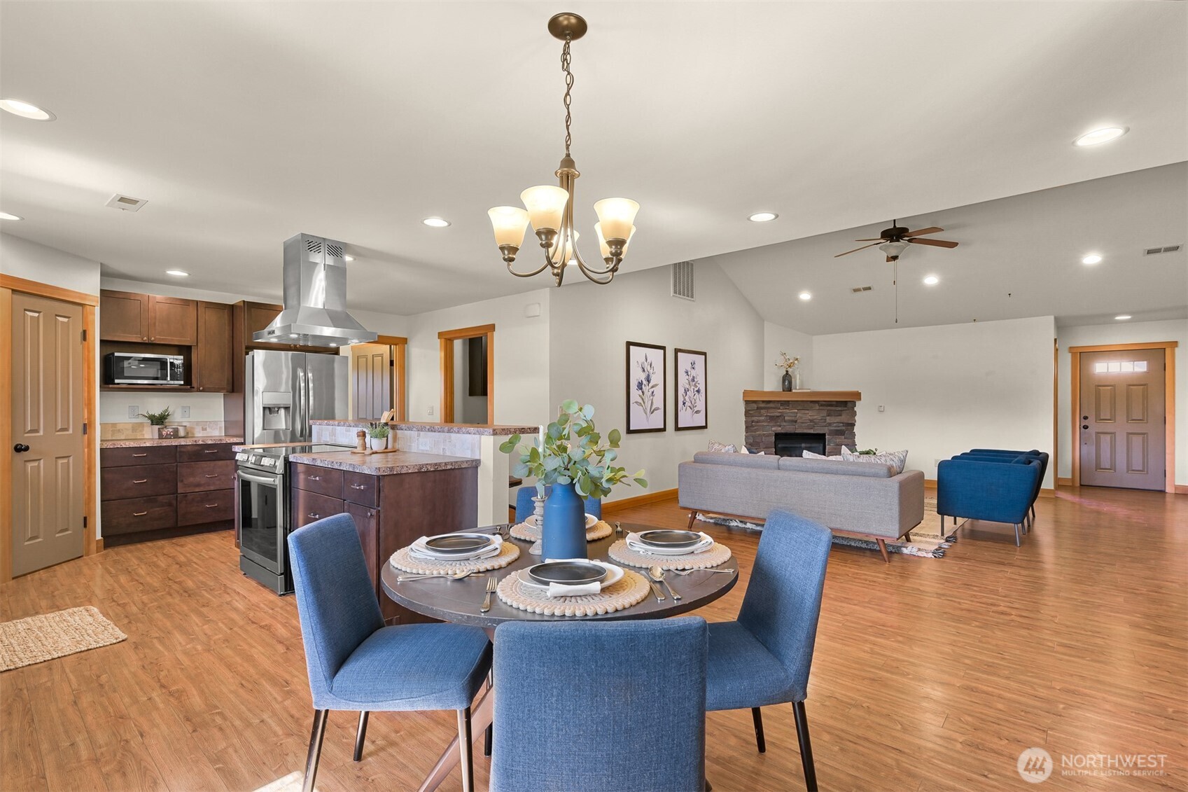 403 Westview Place Nooksack, WA 98276 - Photo 14 of 28 a view of a dining room and livingroom with furniture a rug a chandelier and wooden floor