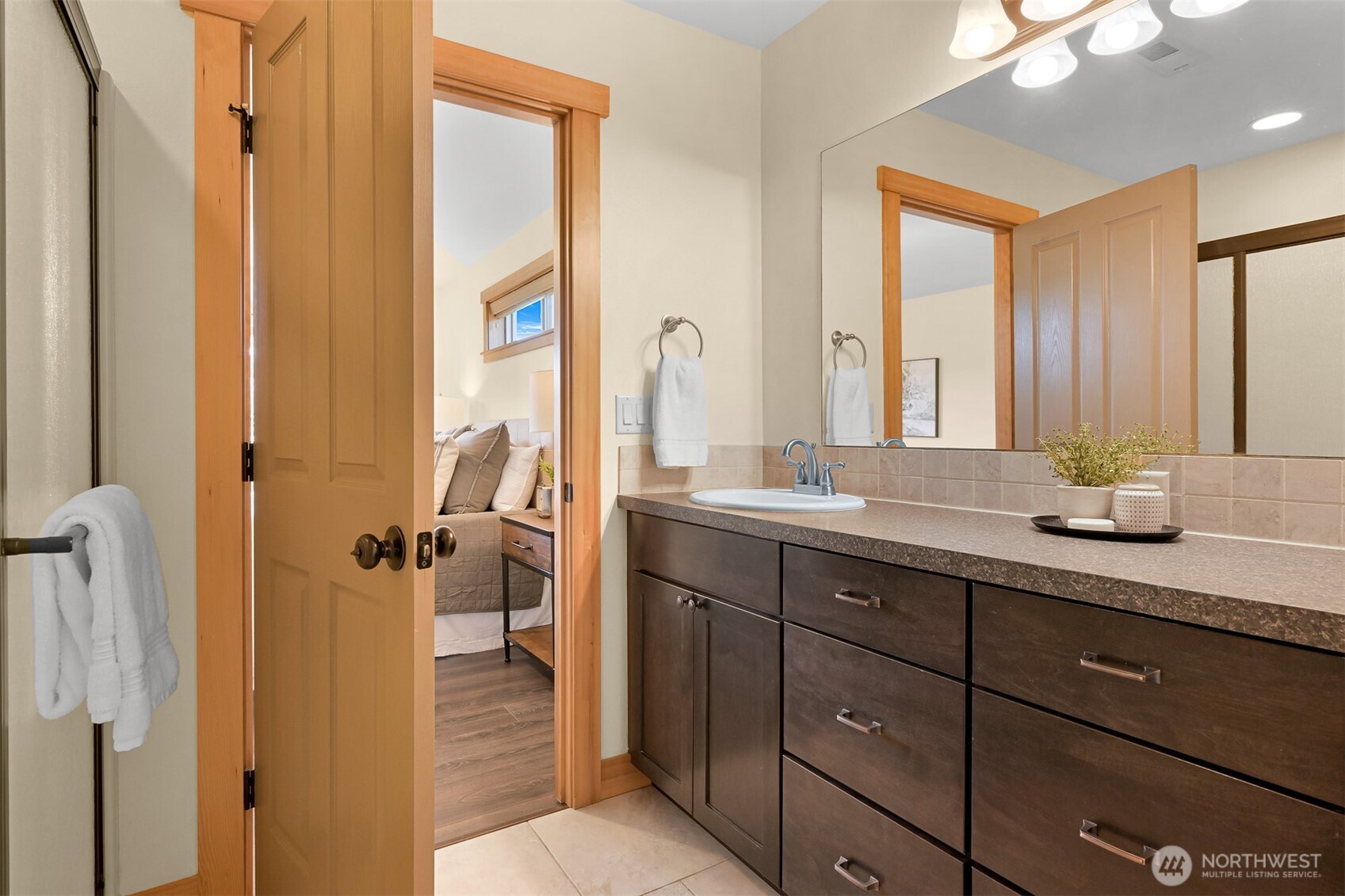 403 Westview Place Nooksack, WA 98276 - Photo 17 of 28 a bathroom with a granite countertop sink a mirror and a shower