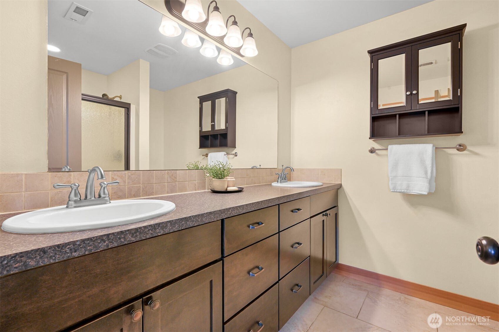 403 Westview Place Nooksack, WA 98276 - Photo 18 of 28 a bathroom with a granite countertop sink a large mirror and a shower