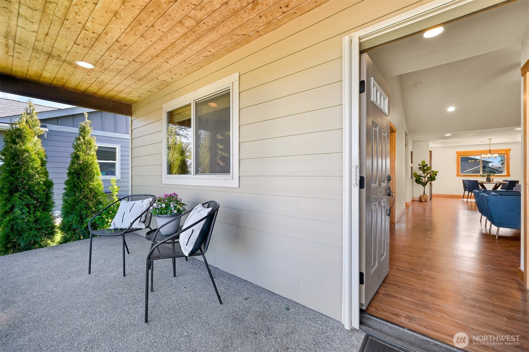 403 Westview Place Nooksack, WA 98276 - Photo 3 of 28 a view of a patio with table and chairs with wooden floor and plants