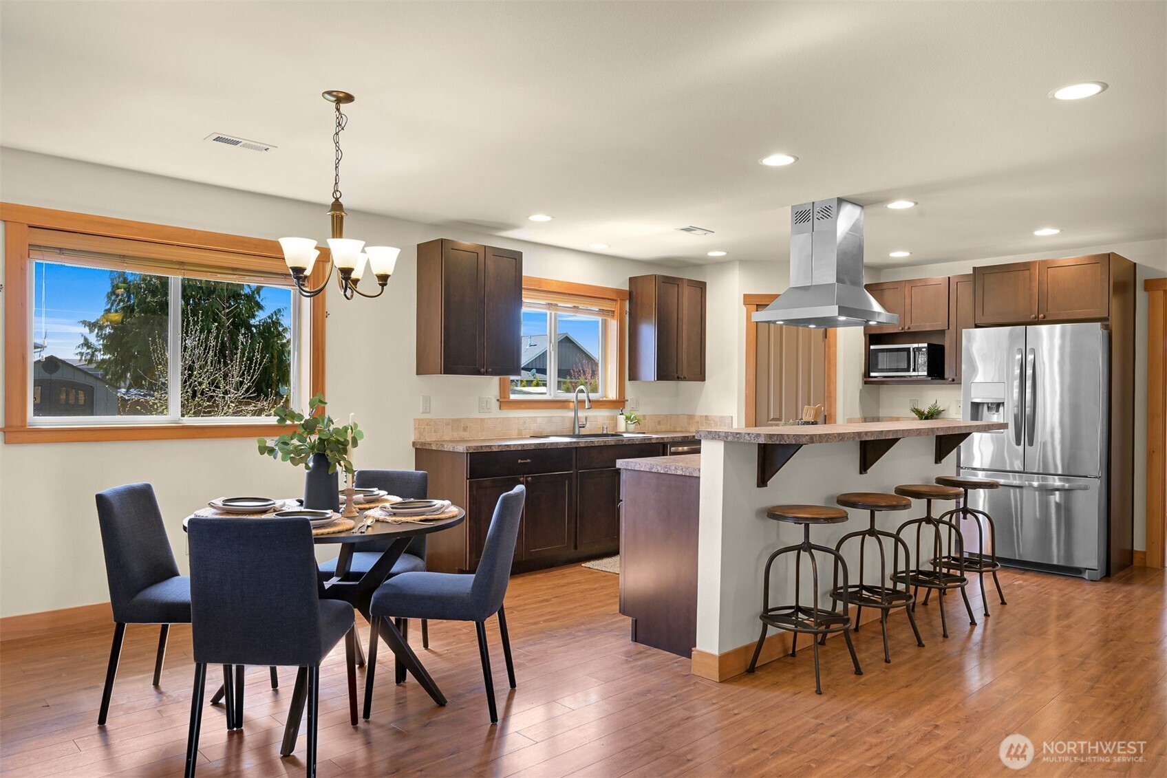 403 Westview Place Nooksack, WA 98276 - Photo 8 of 28 a dining room with stainless steel appliances kitchen island granite countertop a dining table chairs and granite counter tops