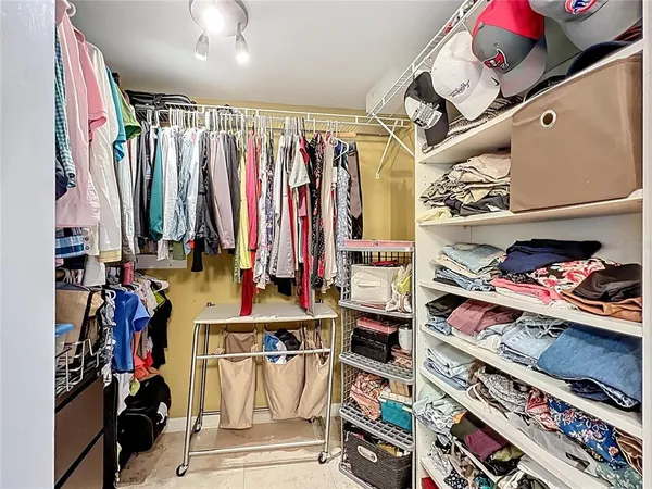 a bedroom with a large bed and a tv on the dresser