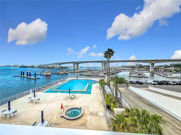 a view of a terrace with lawn chairs