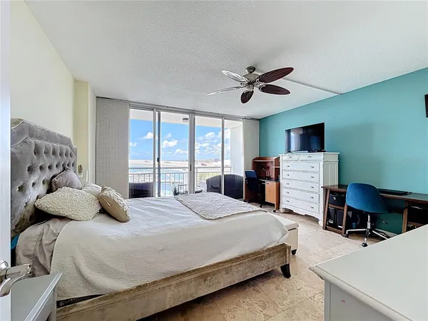 a bedroom with a bed a desk and chair