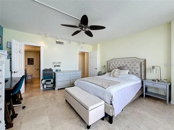 a bedroom with a bed and a chandelier