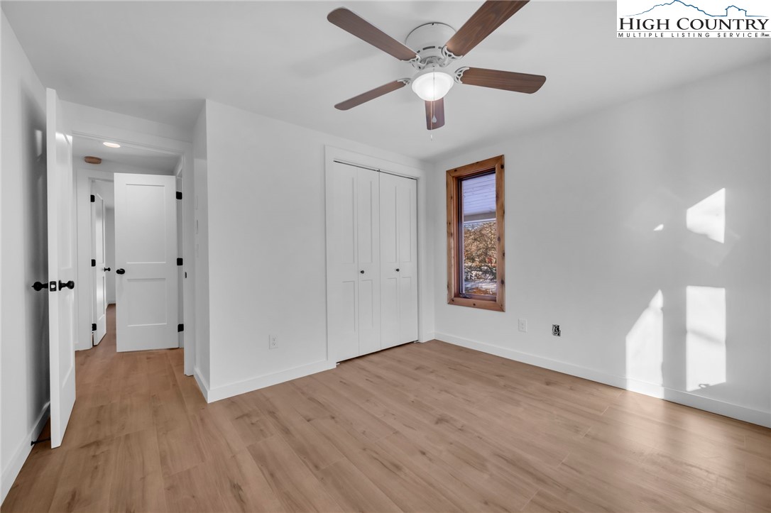 208 Meadow Loop Newland, NC 28657 - Photo 14 of 46 wooden floor in an empty room with a window