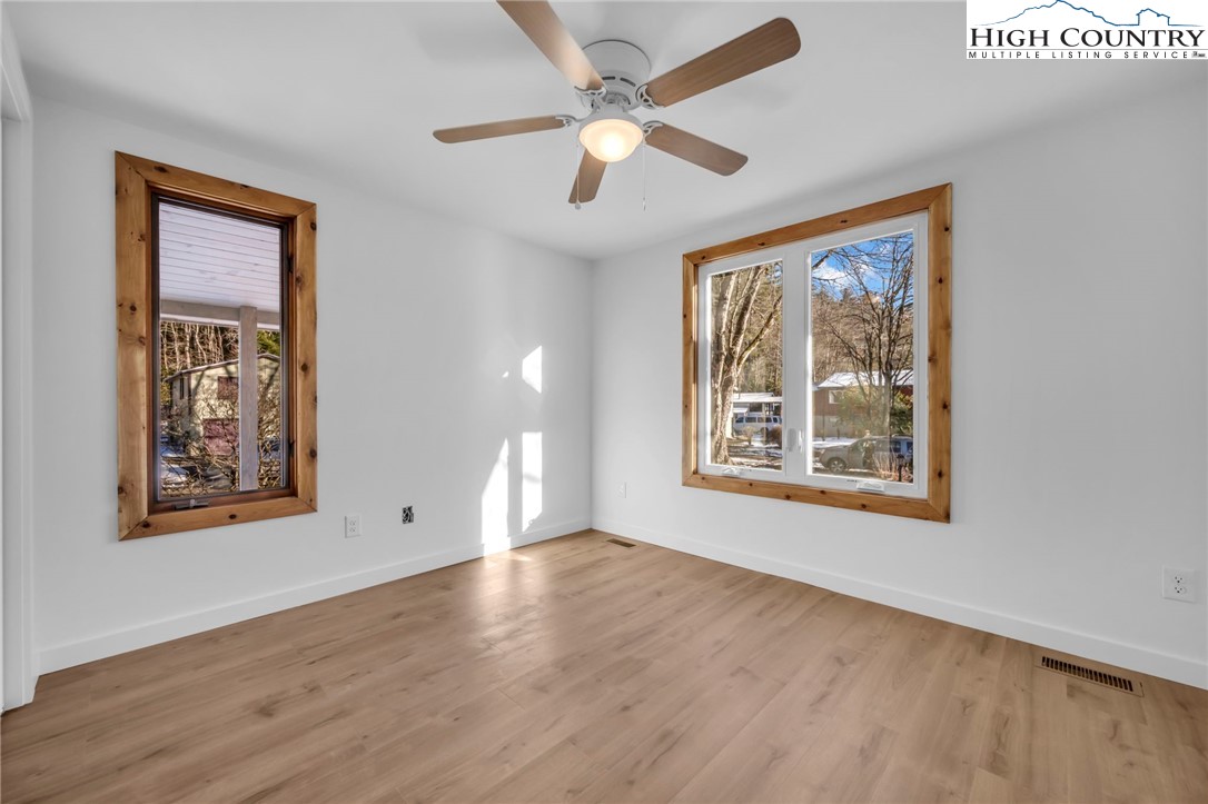 208 Meadow Loop Newland, NC 28657 - Photo 15 of 46 a view of an empty room with a window and wooden floor