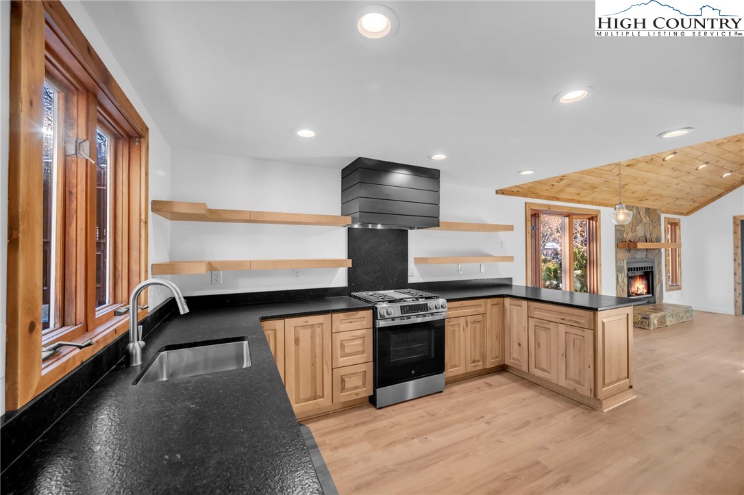 208 Meadow Loop Newland, NC 28657 - Photo 3 of 46 a kitchen with stainless steel appliances granite countertop a stove and a sink