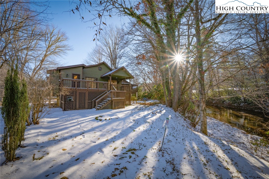 208 Meadow Loop Newland, NC 28657 - Photo 43 of 46 a wooden bench sitting under a large tree