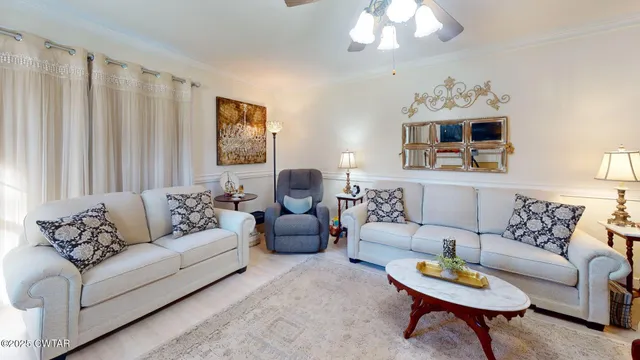 a living room with furniture a chandelier and a couch