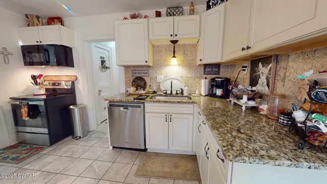 a kitchen with refrigerator and cabinets