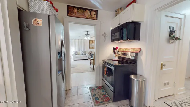 a kitchen with stainless steel appliances granite countertop a refrigerator and a stove