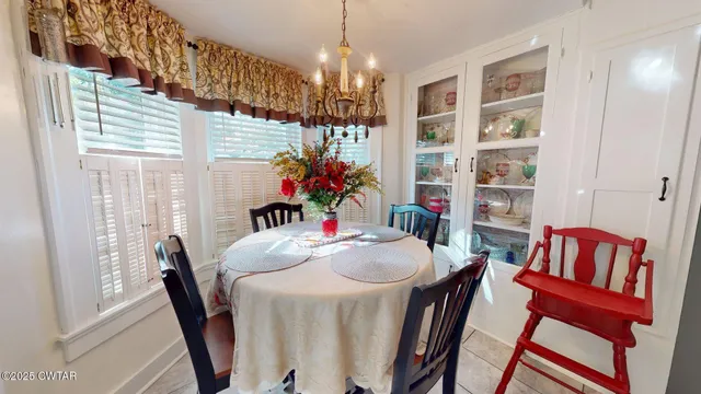 a view of a dining room with furniture and chandelier