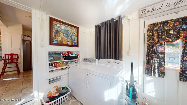 a view of patio with chairs and a table and chairs under an umbrella