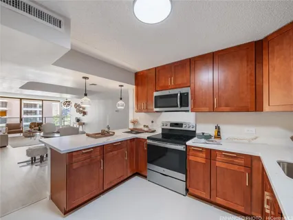 a kitchen with a sink stove and cabinets