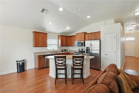 a kitchen with stainless steel appliances granite countertop a refrigerator a stove microwave and cabinets