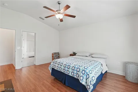 a bedroom with a bed and wooden floor