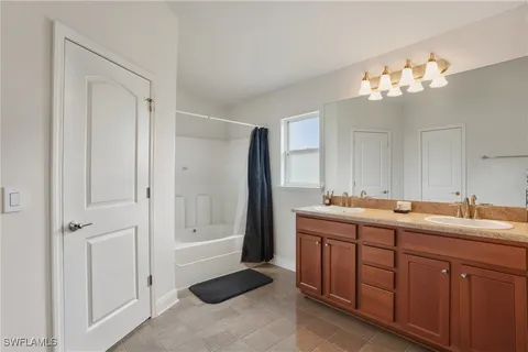 a bathroom with a double vanity sink and a mirror
