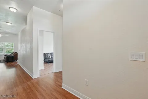 a view of a hallway with wooden floor