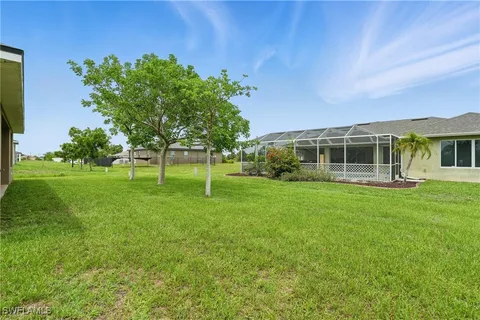 a view of house with backyard space and garden