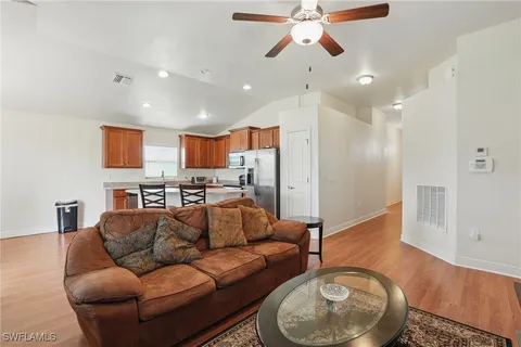 a living room with furniture and a wooden floor