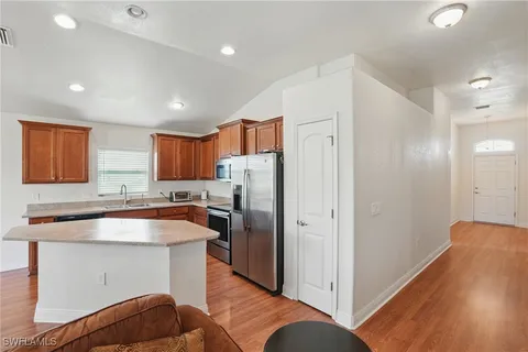a kitchen with stainless steel appliances granite countertop a refrigerator and a sink