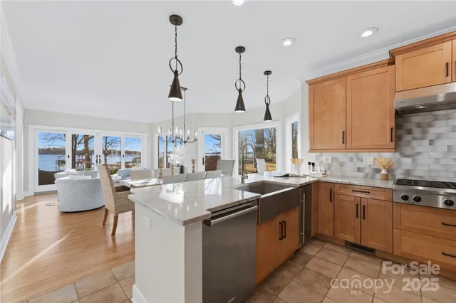 a kitchen with stainless steel appliances granite countertop a sink and stove top oven